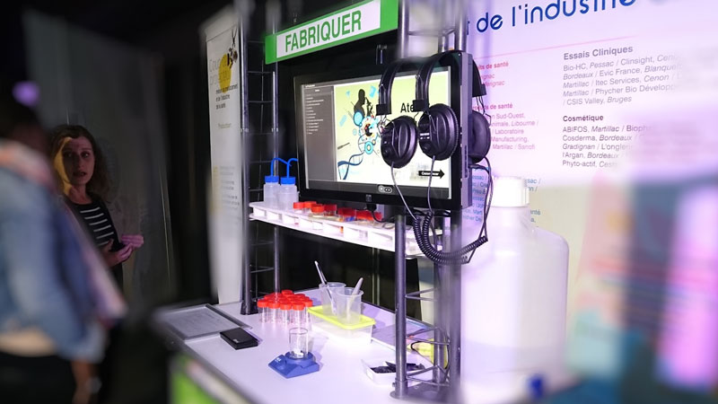 Poste interactif présentant les étapes de fabrication des médicaments dans une exposition sur les métiers des industries de santé.